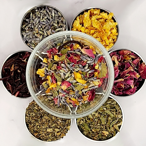 Summer Dream herbal tea herbs in bowls surrounding bowl of tea blend