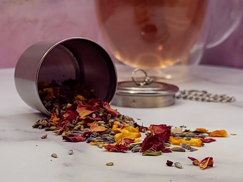 Summer Dream tea herbs spilling out of tea infuser